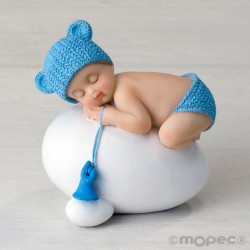 Figura niño bebé azul durmiendo sobre huevo